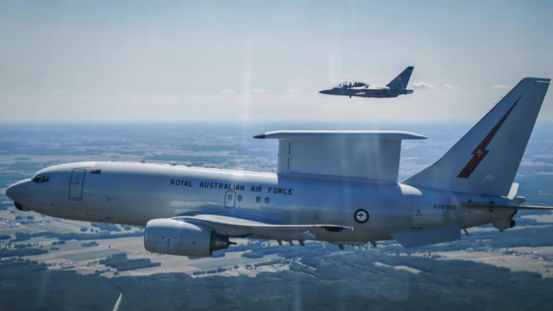 A Royal Australian Air Force E-7A Wedgetail flies alongside a Polish fighter aircraft during a deployment to Operation Kudu in Poland..