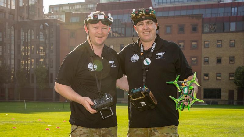 Two Army drone racers handle their aircraft at Royal Military Academy Sandhurst.