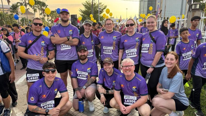 Navy crew in running gear before the start of a half Marathon in Malaysia.