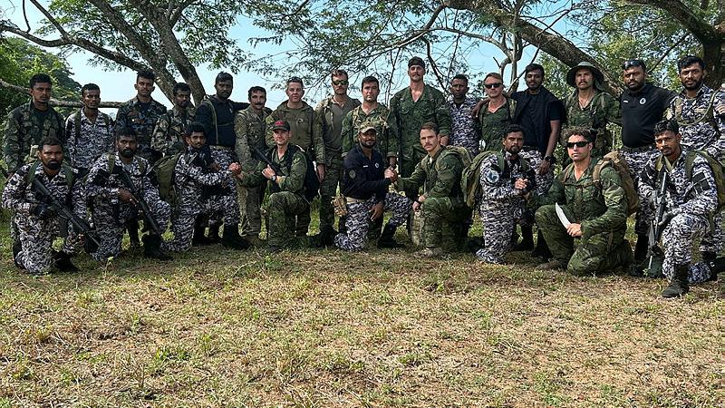 Defence personnel from Australia, the US and Sri Lanka stand in a group outdoors.