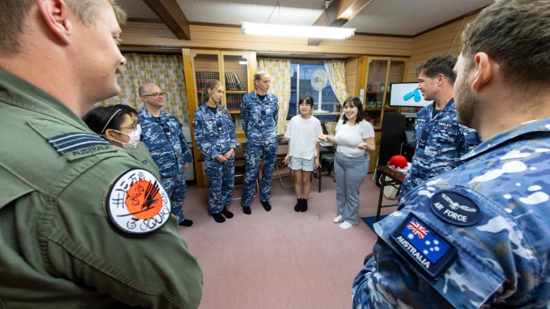 Air Force aviators participate in classroom games with students in Japan.