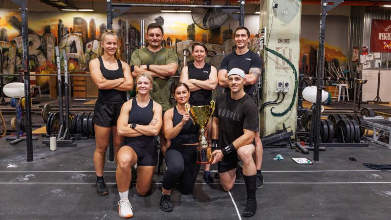 Men and women wearing athleisure in a gym.