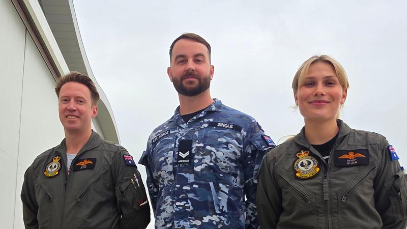 Three Air Force personnel in a row prepare to leave Europe after deployment with NATO.