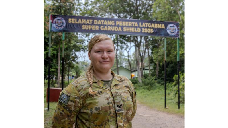 A female soldiers poses for the camera while on exercise in Indonesia.