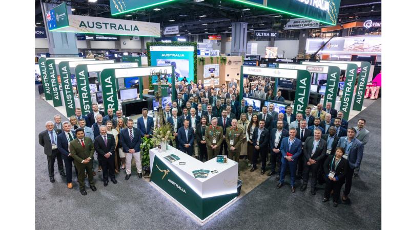 A group of military personnel and civilians at an expo.