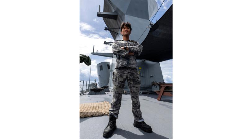 A man in military uniform aboard a ship.