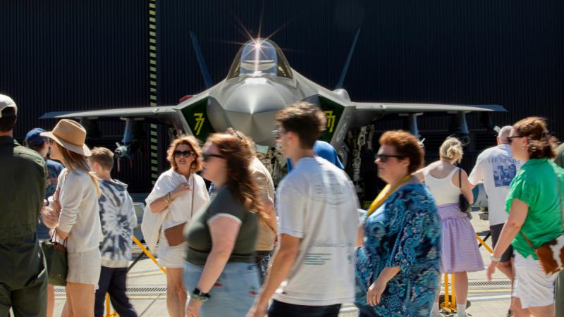 Family and friends file past an F-35A Lighting II static display at RAAF Base Williamtown.