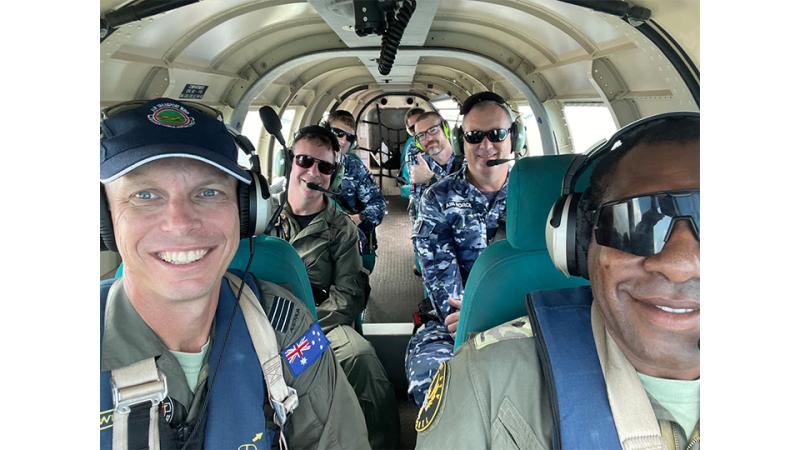 Military personnel inside an aircraft.