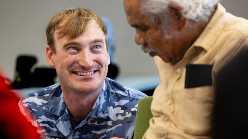 Flight Lieutenant Lachlan Gardiner smiling at Uncle Laurie while the pair are in conversation.