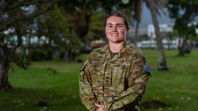An Australian Army officer stands amid trees in Samoa.