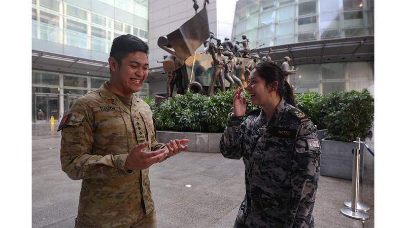 A woman and man in military uniform.