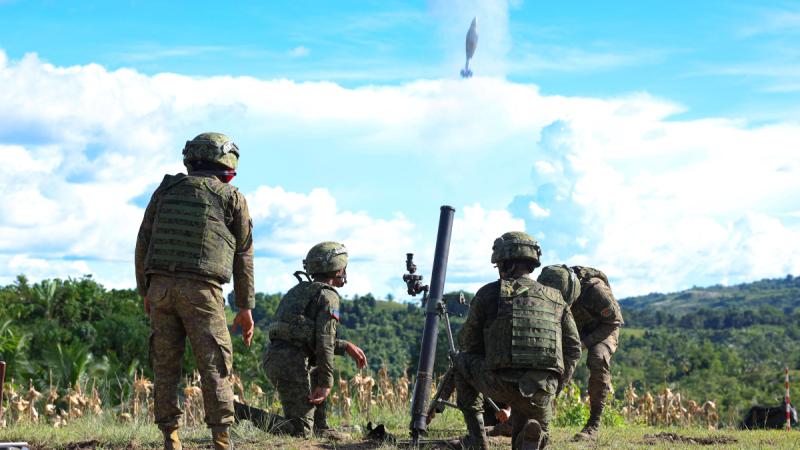 Filipino soldiers fire a mortar shell in the jungle during a joint exercise with Australian soldiers.