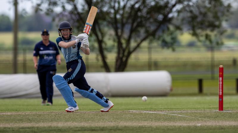 An Air Force women's cricket strikes the ball during the ADF championship.
