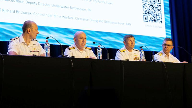 From left, Commander Marcus Rose, Rear Admiral Tom Phillips, Rear Admiral Christopher Cavanaugh and Commander Daniel Sutherland speak at the underwater warfare panel during Indo Pacific 2025. Photo: Able Seaman Taylor Johnson 