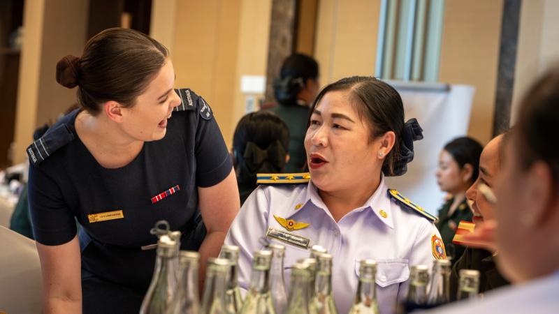 An Australian and Laotian officer meet at a conference in Laos.