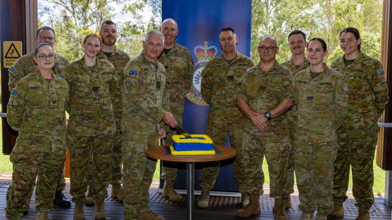 Air Force personnel from 96 Wing celebrate their 25th anniversary at RAAF Base Amberley, Qld, with a cake.