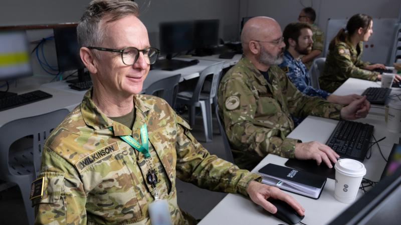 An Australian Army soldier at a computer terminal operates cyber systems during a major exercise.