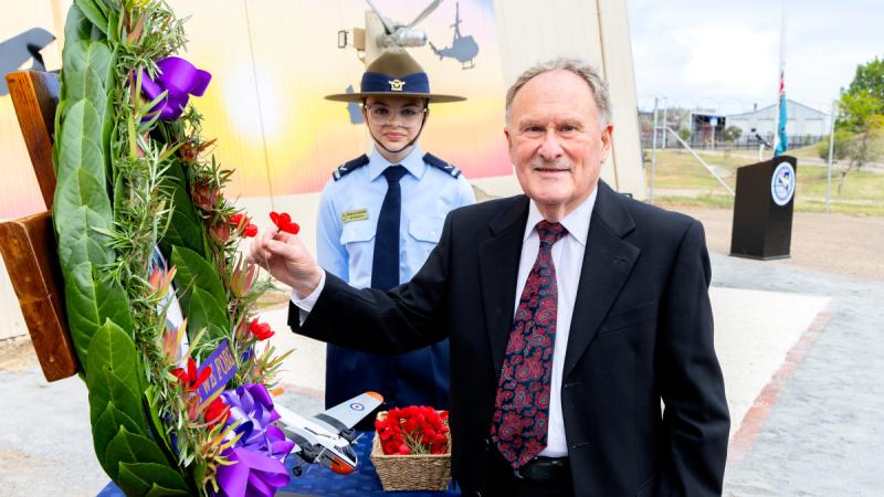 A relative lays a poppy at a memorial to Air Force aviators lost in peacetime accidents.