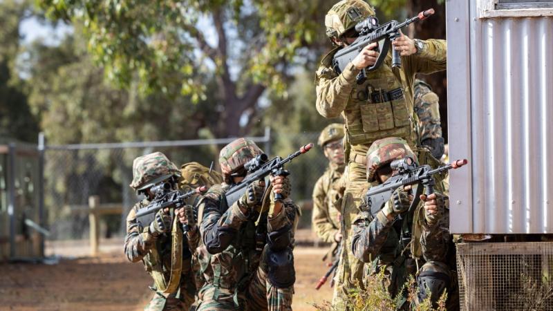 Australian and Indian soldiers combine in an assault group on exercise.