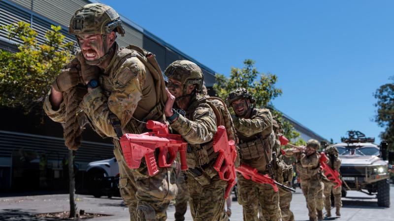 Australian Army soldiers pull a vehicle during a military skills competition.