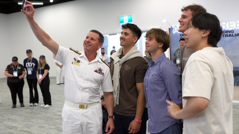 Chief of Navy takes a selfie with students at the Navy Life Expo.