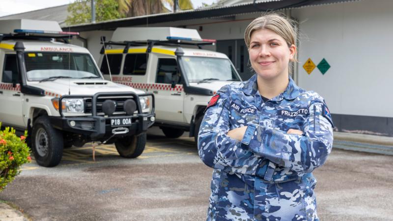 An Air Force medical officer stands before ambulances at Butterworth, Malaysia.