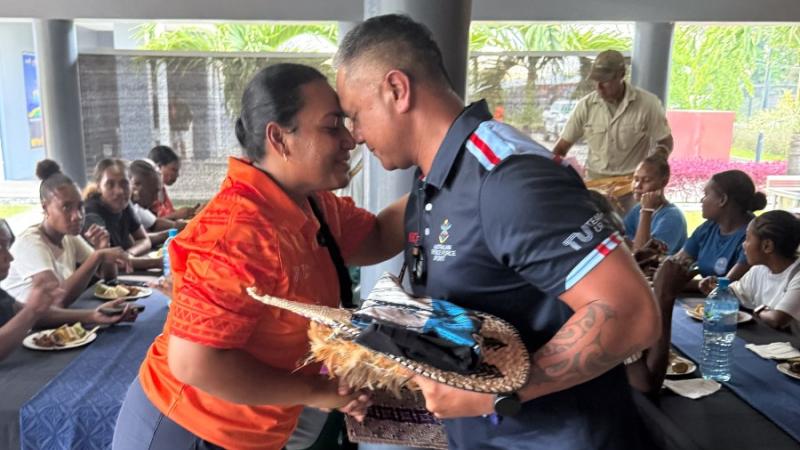 A Solomon Islander woman and an ADF soldier exchange traditional greetings in Honiara.