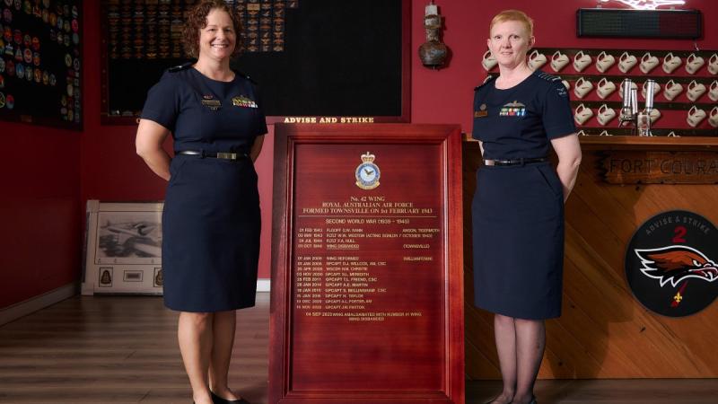Two senior Air Force officers with the 42 Wing history and command board during the official disbandment ceremony. 
