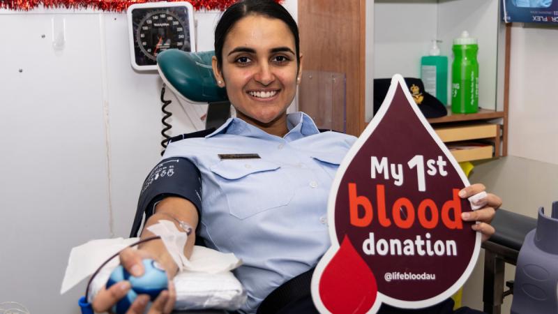 An air force officer donates blood. 