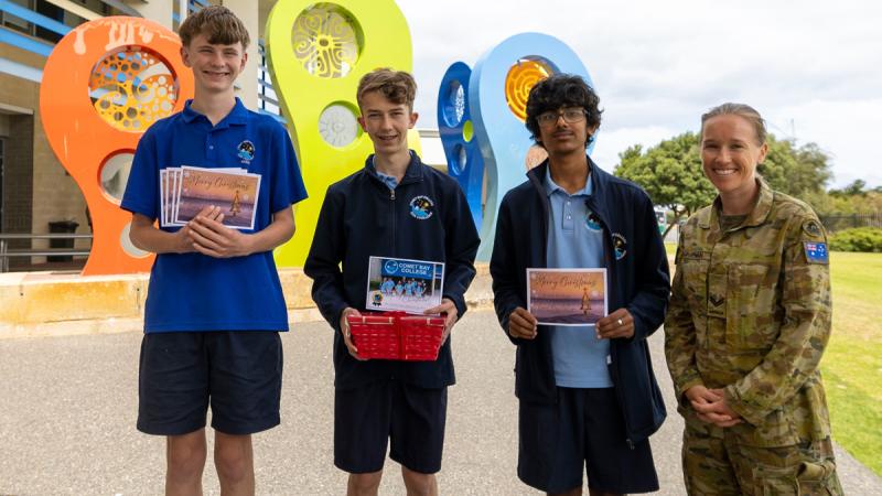 Comet Bay College students present handwritten Christmas Cards for Australian Defence Force members on deployment. 