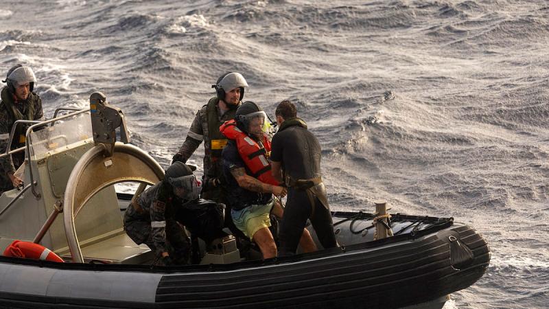 HMAS Choules personnel rescue Lithuanian solo adventurer Aurimas Mockus off the Queensland coast. Photo: Chief Petty Officer Helen Frank