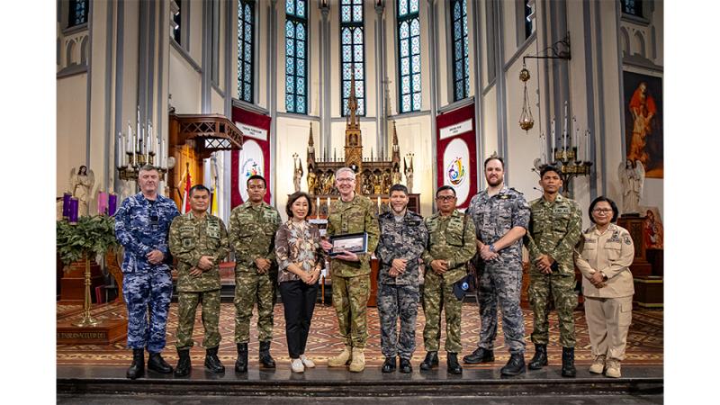 A group of military personnel gather in a place of worship.