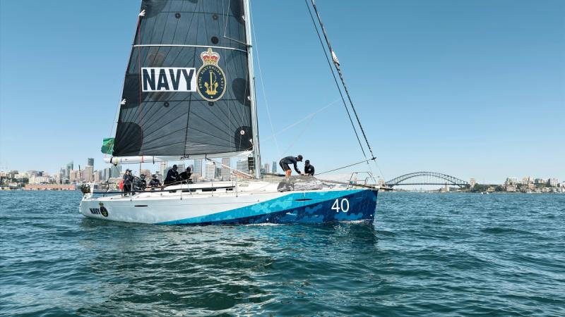 The Royal Australian Navy's yacht, Navy One, sets sail on the harbour during the Sydney to Hobart 2025 race.