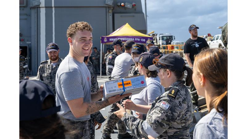 Personnel pass packages between each other.