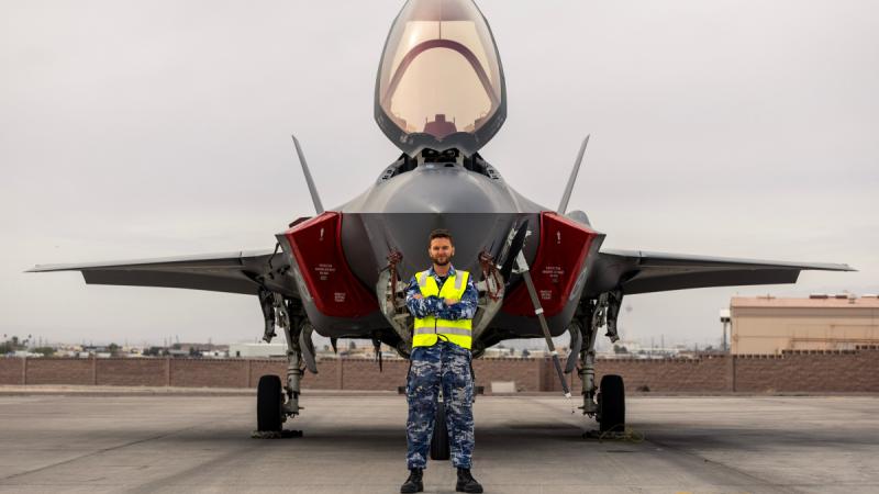Royal Australian Air Force Aircraft Technician, Leading Aircraftman Rory Kerr, stands in front of an F-35A Lightning II aircraft during Exercise Red Flag 26-1 at Nellis Air Force Base, United States.