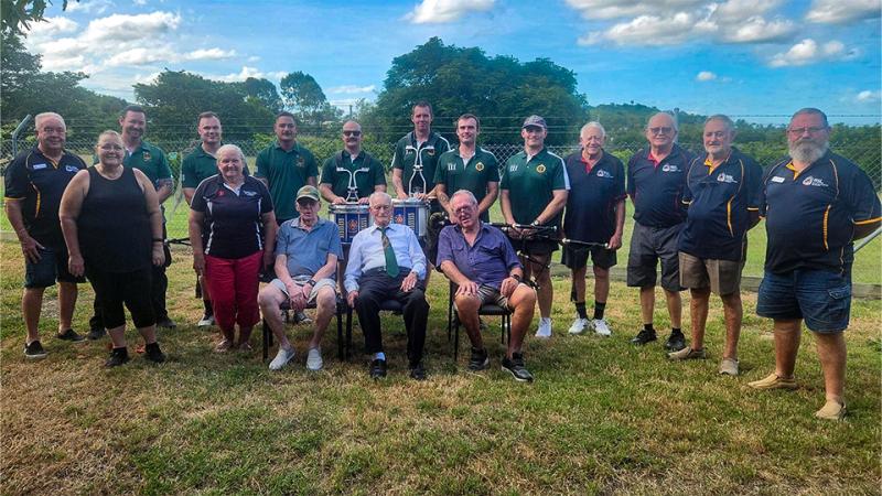 A group of young and elderly people outside.