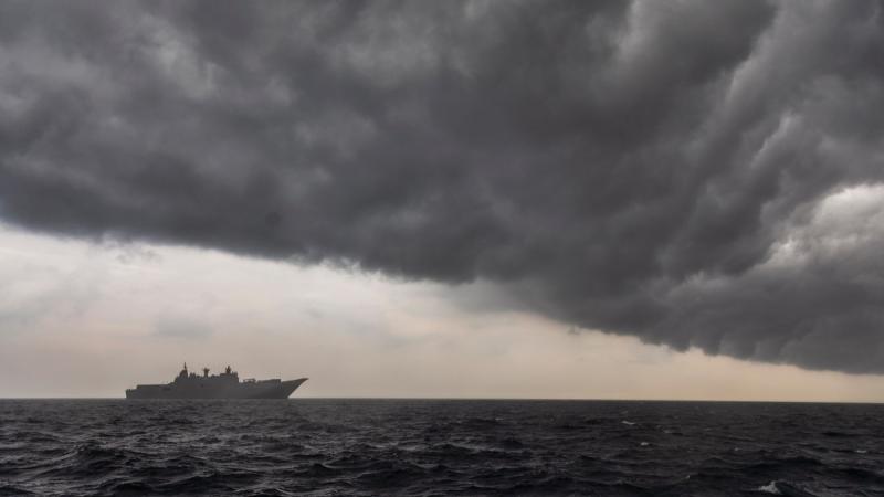 A ship sailing into a storm.