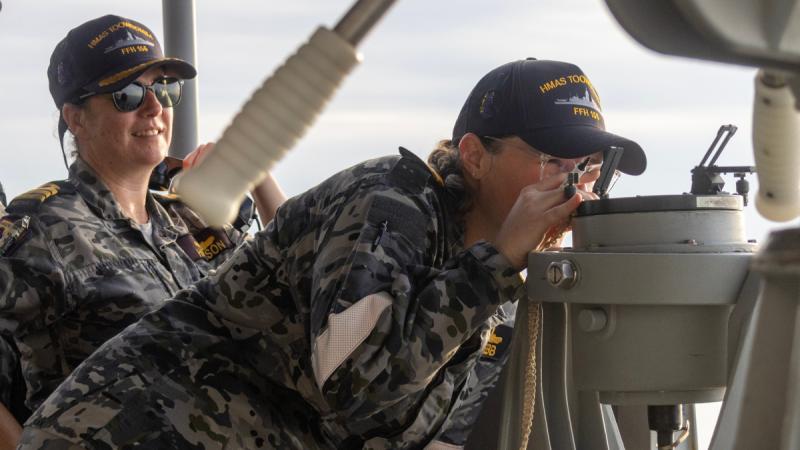 Lieutenant Commander Brianna Webb leans in to view another ship.