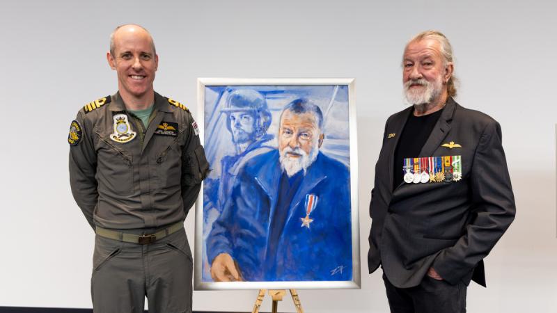 Commanding Officer Joel Cooper and Andy Perry in front of the artwork.
