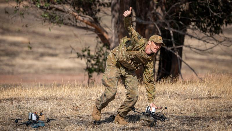 An Australian Army soldier signals 'all clear' to launch a drone using First Person View google during the Modify and Operate Attack Drone (FPV) Course at Puckapunyal Military Area, Victoria.