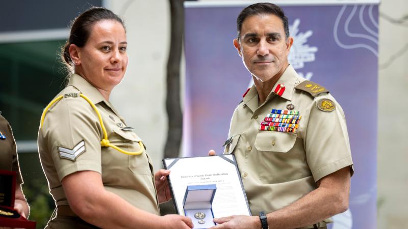 Chief of Army, Lieutenant General Simon Stuart AO DSC, awards recipient Corporal Sarah Vella the Jonathan Church Good Soldiering Award during the Army 125th Birthday at Russell Offices, Canberra.