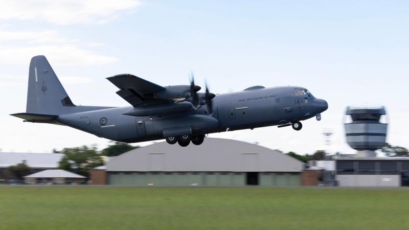 A large aircraft takes off from a runway.