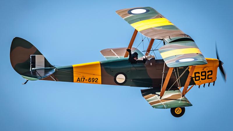 A person waves from an aircraft.