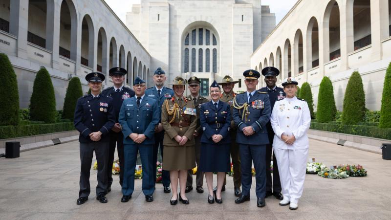 A group of military personnel standing in a group in front of the Australian War Memorial.