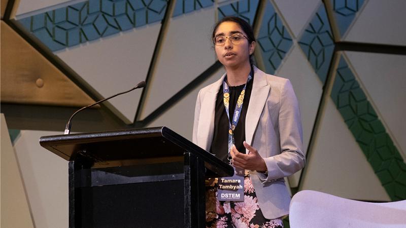 A woman talks from a lecturn.