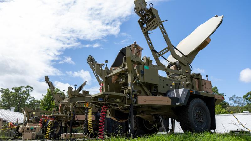Army trucks with satellite communications systems attached. 