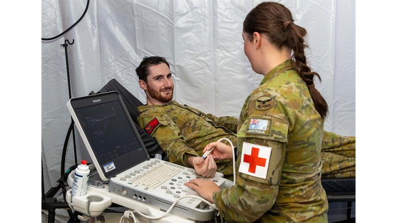 A military member assesses the health of another military member.