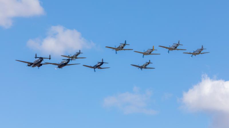 Seven aircraft flying in formation.