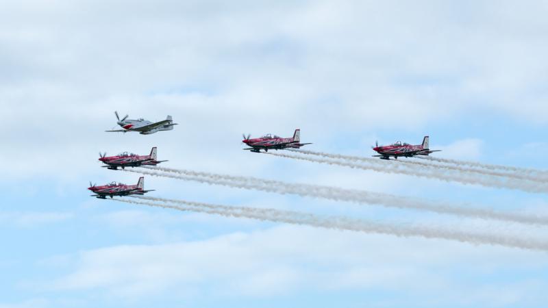 Five heritage aircraft flying in formation.