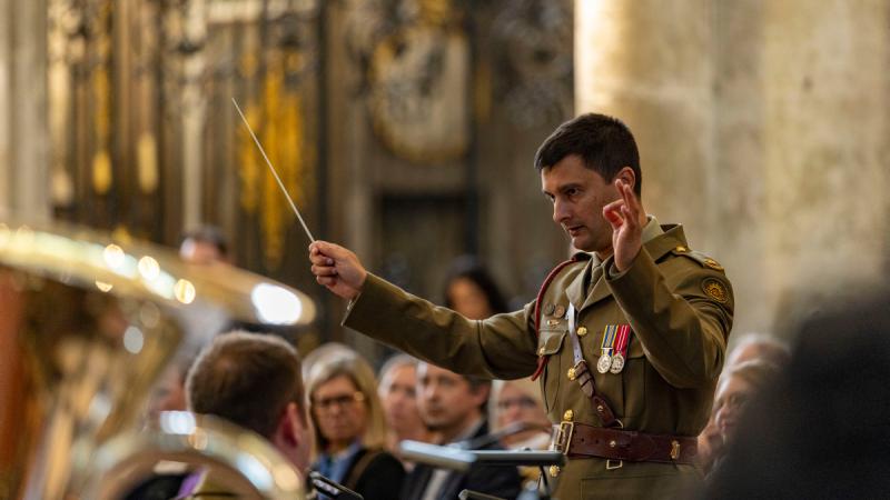 Army Major Doug Hall conducts the band in Amiens.
